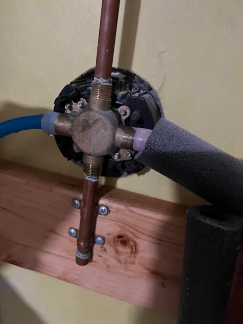 Freeze-damaged shower mixing valve with copper and PEX supply lines