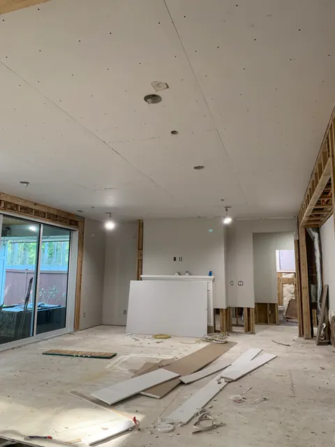 Great room during restoration with new drywall being hung after mitigation