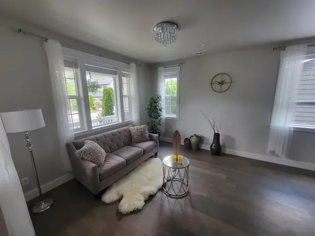 Restored living room with new ceiling, paint and hardwood floor