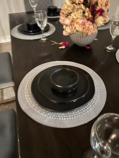 Close-up of a water-stained dining table and place setting